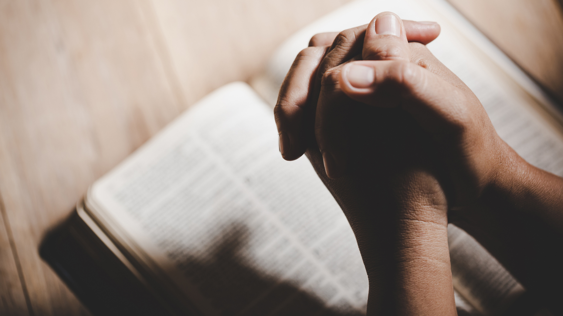 people holding hands in prayer